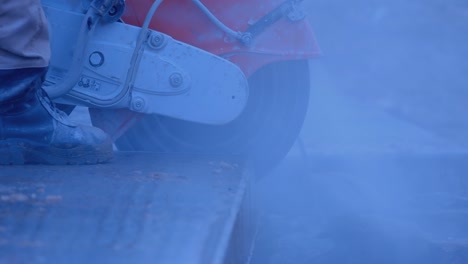 a builder by grinder cuts off part of a thick slab, a lot of sparks and smoke