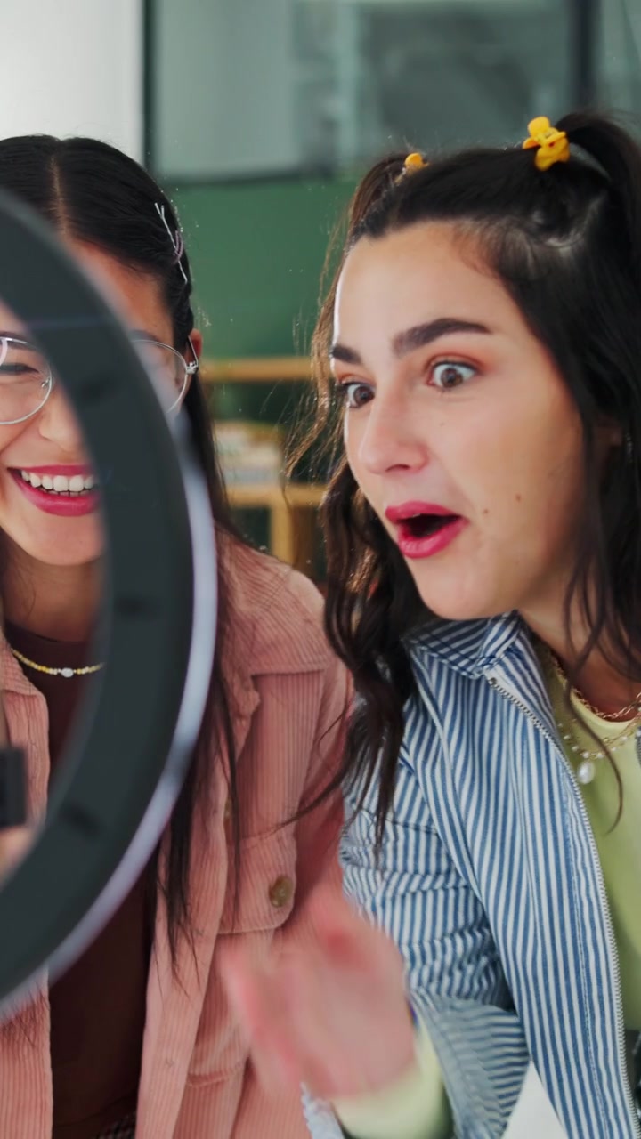 Two Young Women Recording Video Content with Smartphone and Ring Light