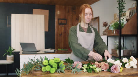 portrait of smiling female florist in flower shop