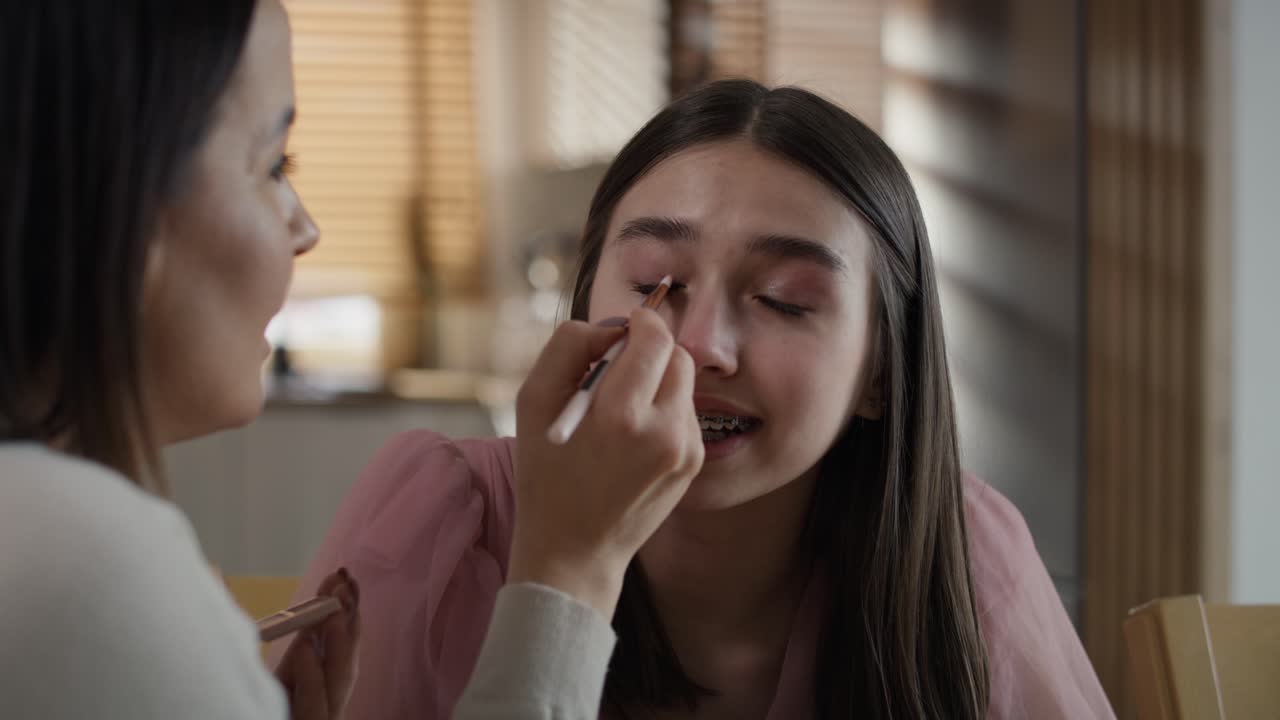 백인 여성 이 딸 을 위해 메이크업 을 하고 있다