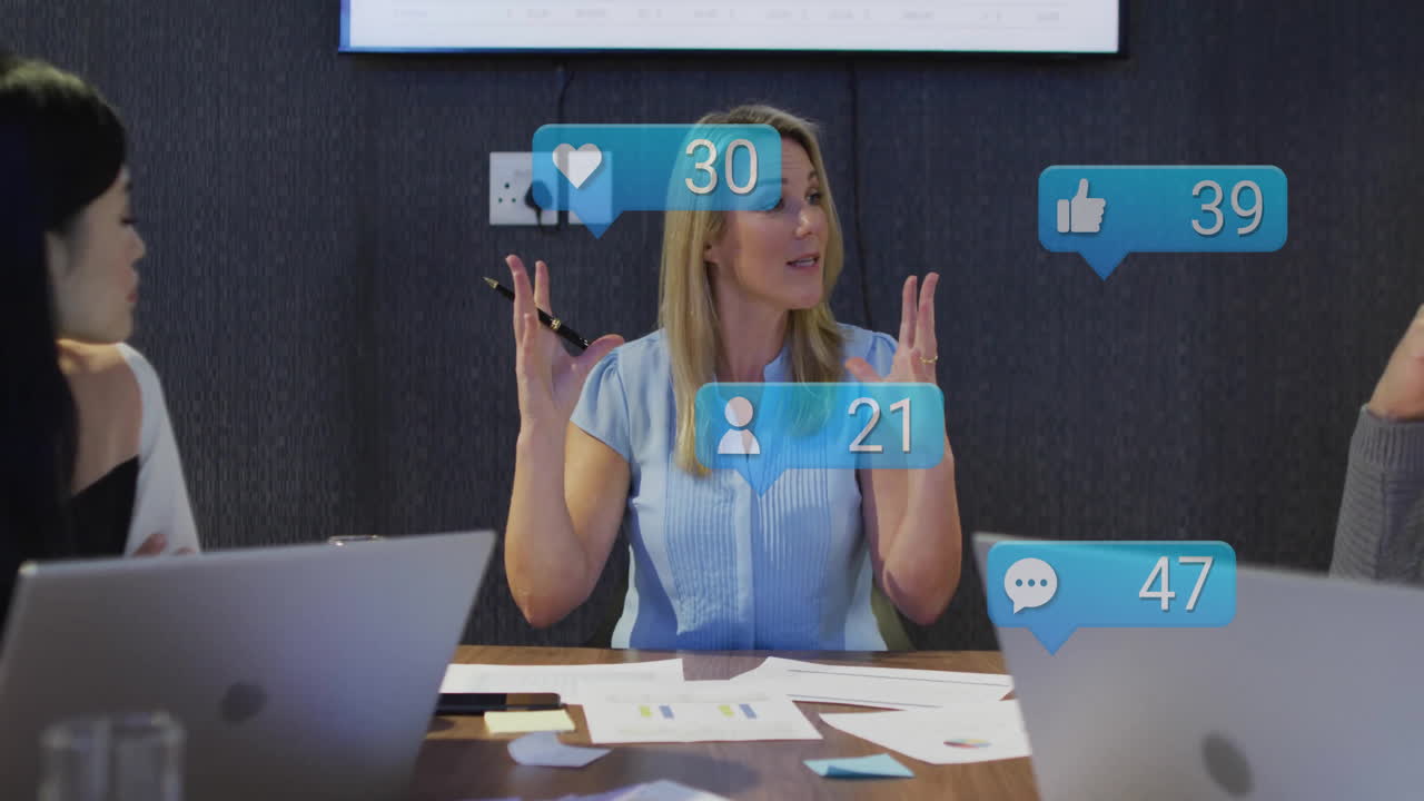 In meeting room, participants discussing with floating social media animation icons