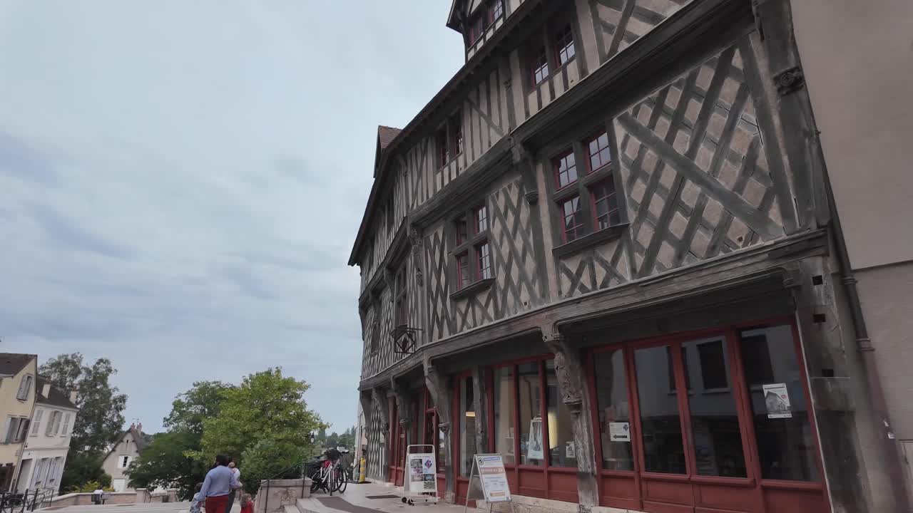 Old town walking tour with wooden beamed houses and parked bicycles on the street, Chartres, France
