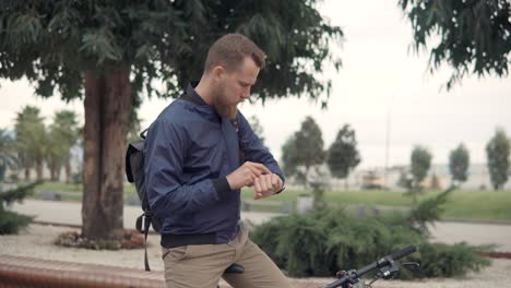 man checking time on his bike