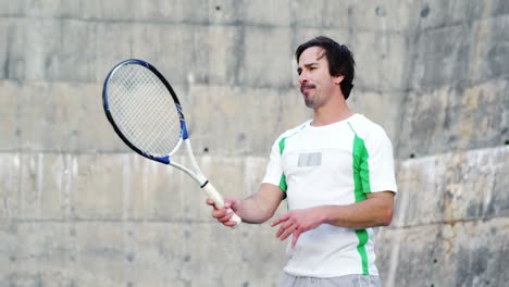 tired sportsman standing with racket