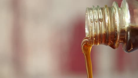 amber liquid pouring from a bottle