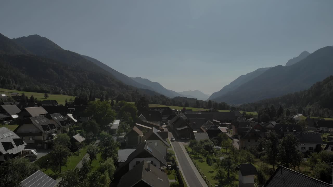 슬로베니아의 사바 계곡에 있는 포드코렌 마을의 드론 영상, 교회, 묘지, 그리고 도로를 지나가는 자동차를 보여준다.