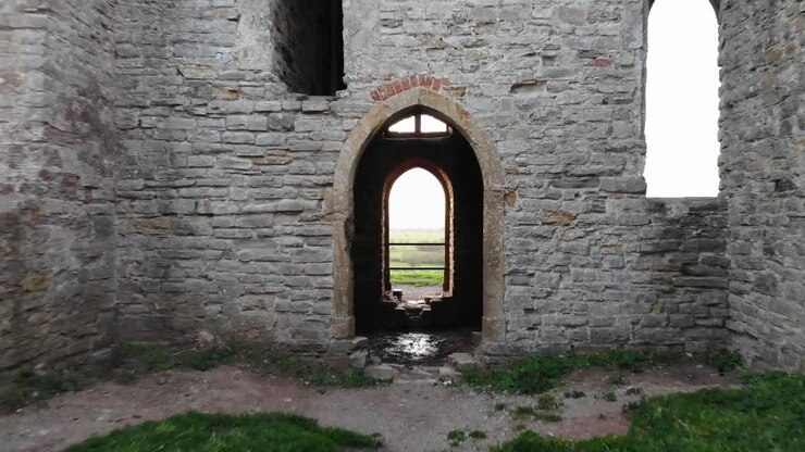 Ripresa che svela a ritroso di un portale delle rovine di una chiesa a Burrow Mump, Inghilterra