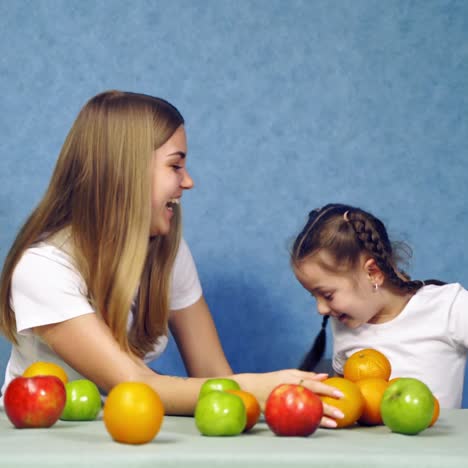. child girl with fruits. little cute child girl funny play construct with organic fruits