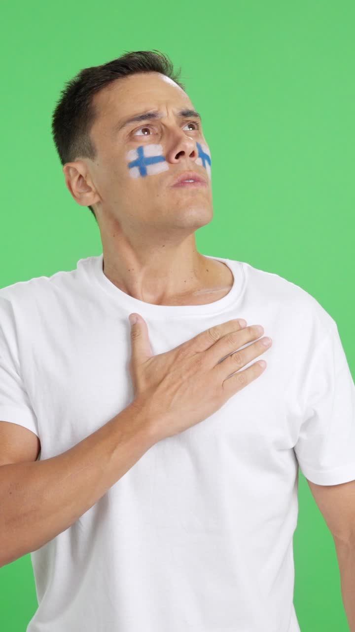 Man listening to the Finland national anthem with solemnity