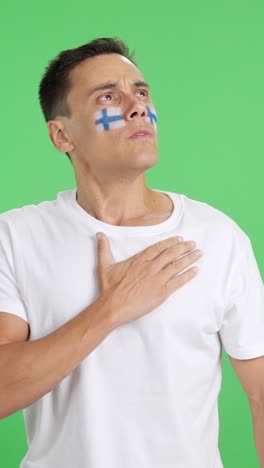 man listening to the finland national anthem with solemnity
