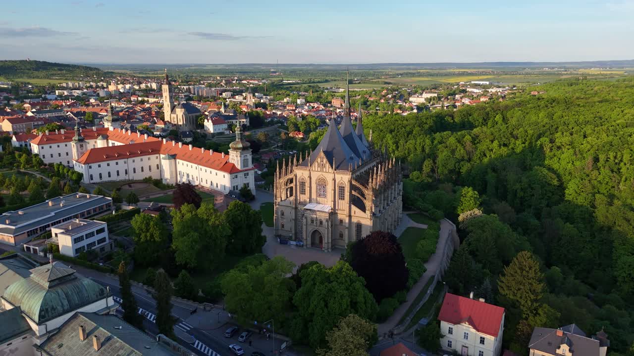 Cathedral centered in Kutna Hora skyline, drone reveals full structure and nearby terrain