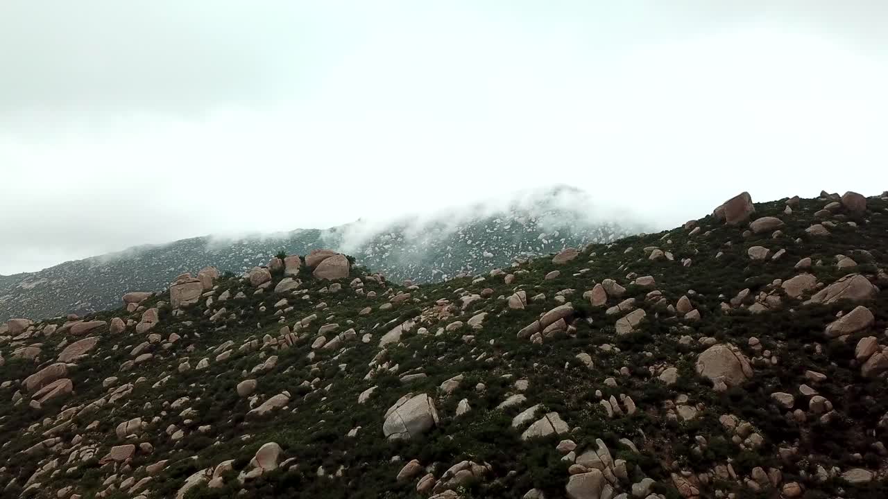 Foggy Mountain Landscape with Rocks and Vegetation