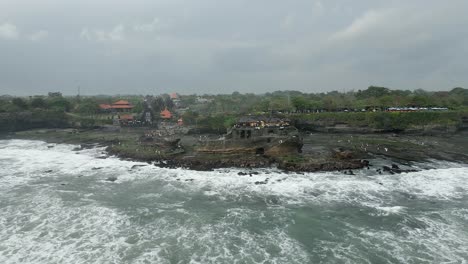 aerial retreats from coastal bali rock formation, tanah lot temple