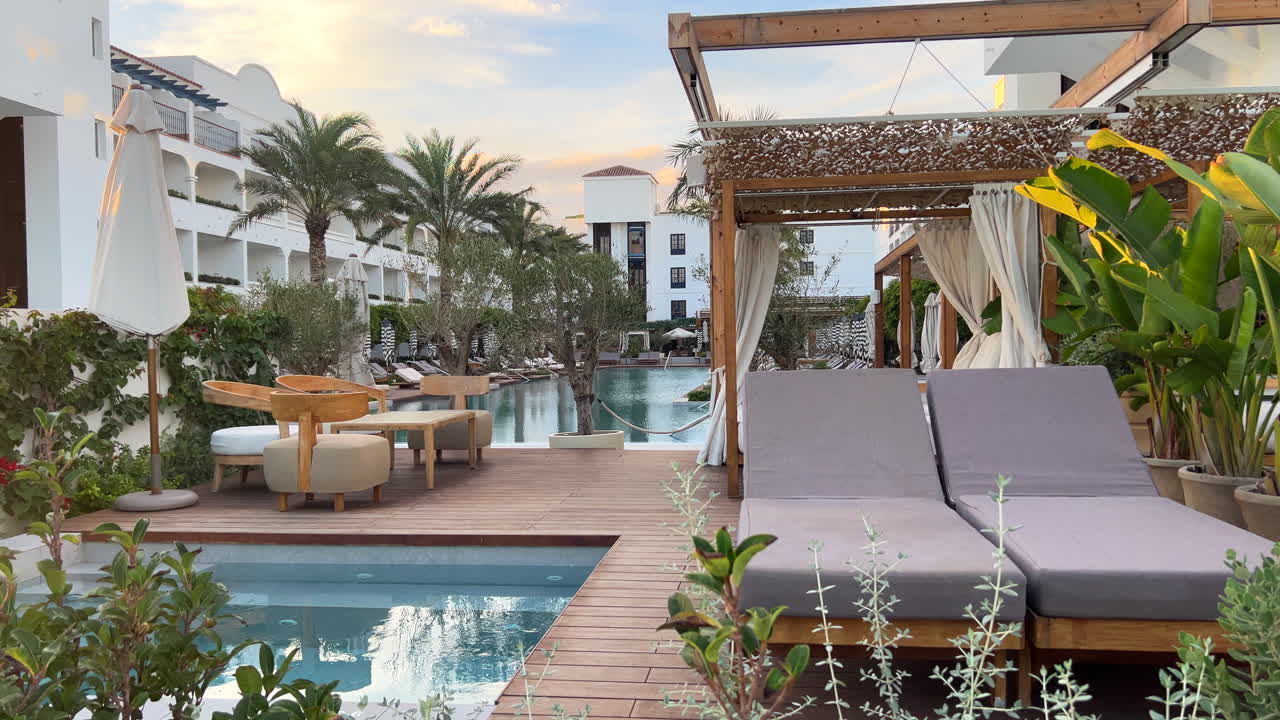 Nice sunbeds at a luxurious fancy beach club in Mett Hotel Marbella Estepona Malaga Spain with a swimming pool, holiday vacation destination, five star experience, 4K static shot