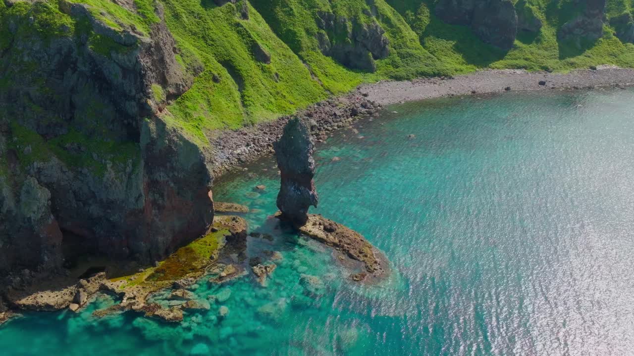 Summer Vibes landscape in Hokkaido Japan, Aerial drone fly at turquoise clean sea water beach cliff with massive stone