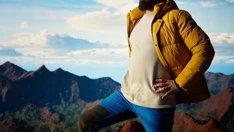 determined climber gazes at the sky and rocky mountain tops