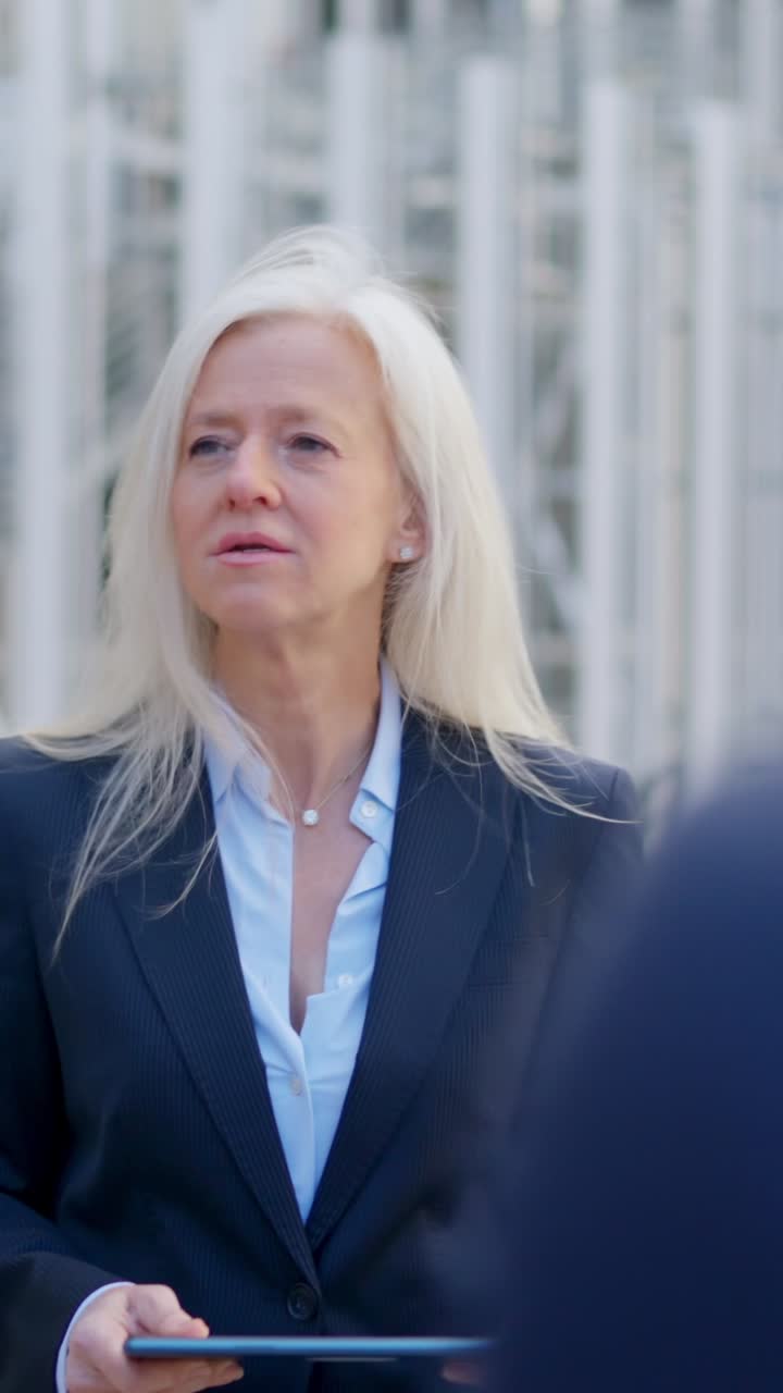 Professional Woman Engaged in an Outdoor Business Conversation