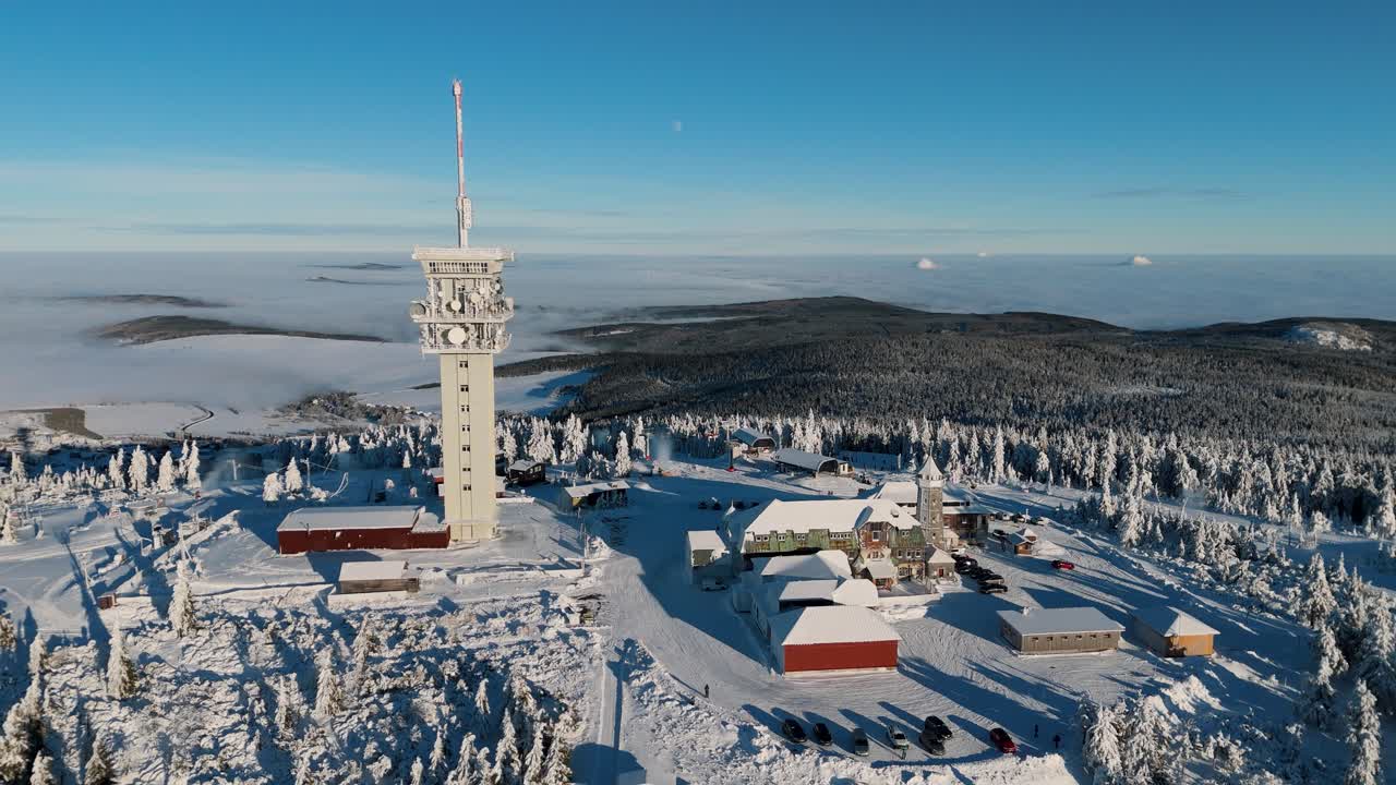Aerial view of czech mountain Klinovec's peak in winter with a communication tower