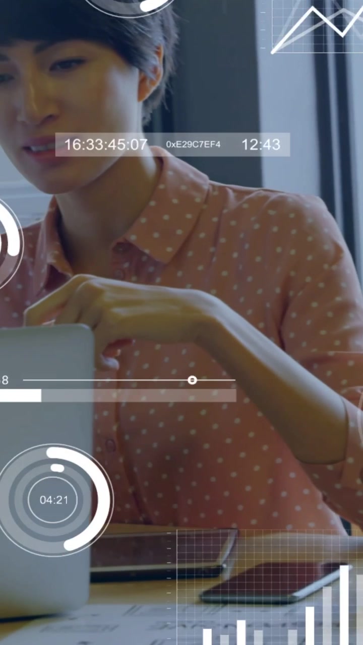 Vertical video: HUD appearing woman leaning into laptop pointing typing guiding decisions with data