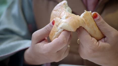 close up of woman eating bread