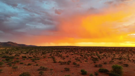 Aerial-panning-of-cloudscape-in-dry-kalahari-landscape-during-golden-hour-of-sunset