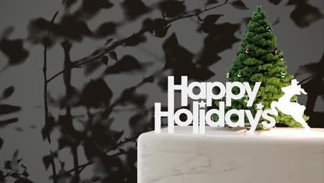 Small-Christmas-tree-with-"Happy-Holidays"-sign-on-marble-platform-with-black-floral-shadow-background