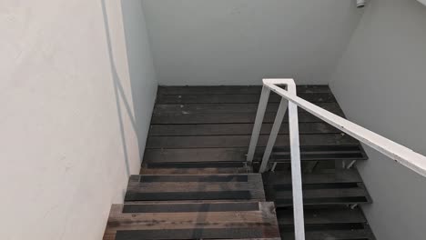 a person walking down a spiral staircase