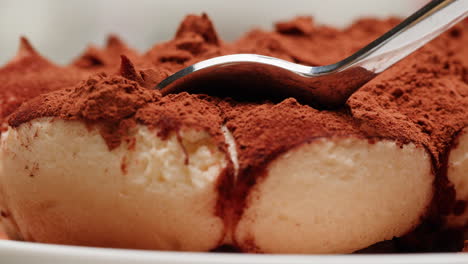 tiramisu being eaten with a spoon
