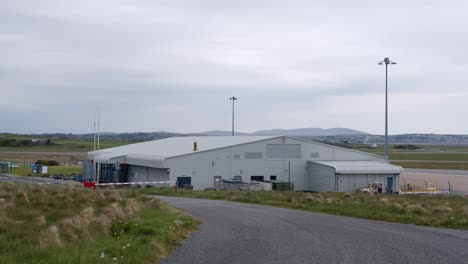 shot of a small airport terminal in front of a distant runway