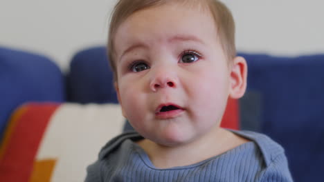 baby playing with rainbow silk ribbons in slow motion