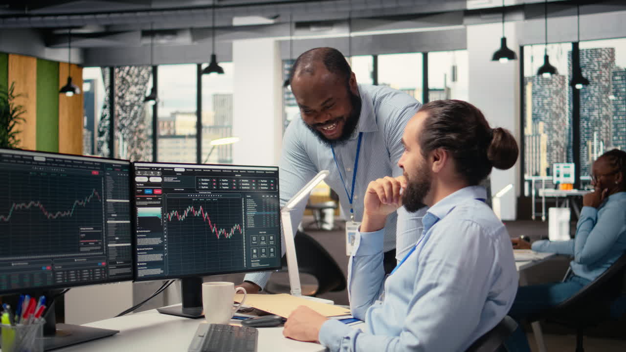 Happy coworkers in office doing high five after successful trading strategy