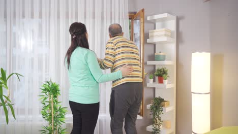 female nurse holding hand of sick man.