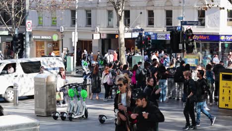 crowded street with pedestrians and scooters