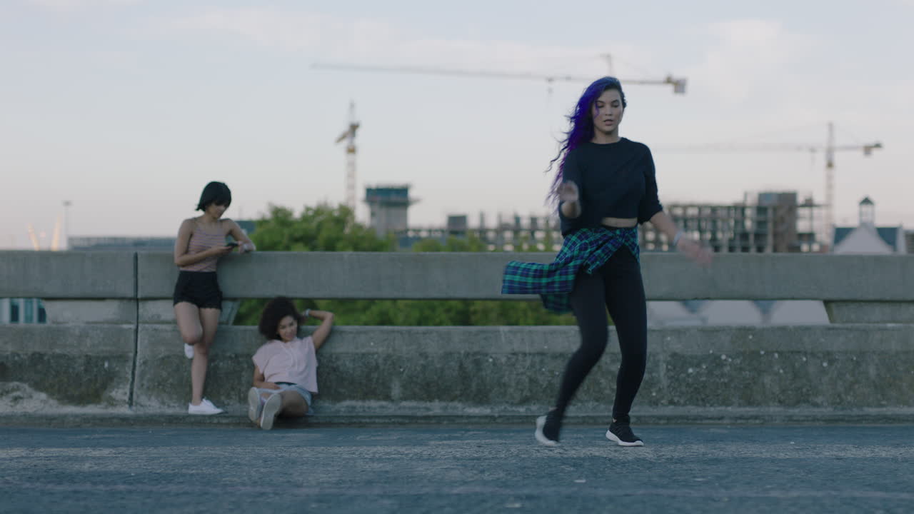 bailarina hermosa bailarina de raza mixta realizando baile callejero de estilo urbano en la ciudad practicando movimientos de estilo libre amigos viendo disfrutar de pasar el rato al atardecer
