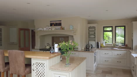 right to left pan of a large contemporary kitchen in a family home in slow motion