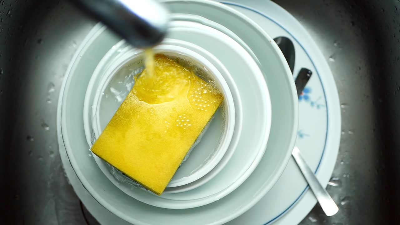 Washing Dishes in a Kitchen Sink