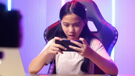 asian kid girl playing video game with mobile phone then lose the game while live stream