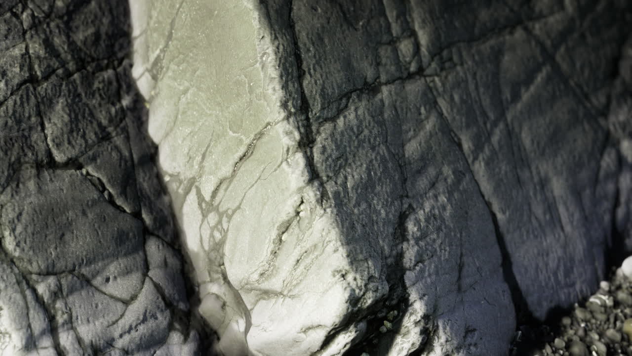 Intricate patterns of rock formations reflect light in a natural setting