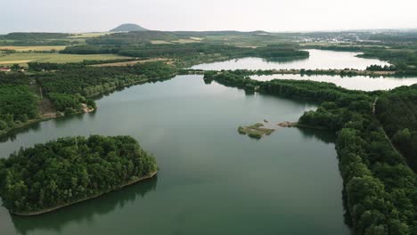 Aerial-view-of-the-peaceful-lake-landscape-with-the-city-in-the-background