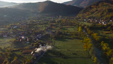 establishing shot over a secluded village at sunset, autumn