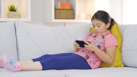 happy girl child stretching on the sofa.