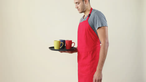 Smiling-waiter-holding-a-tray-with-coffee-cups-4K-4k