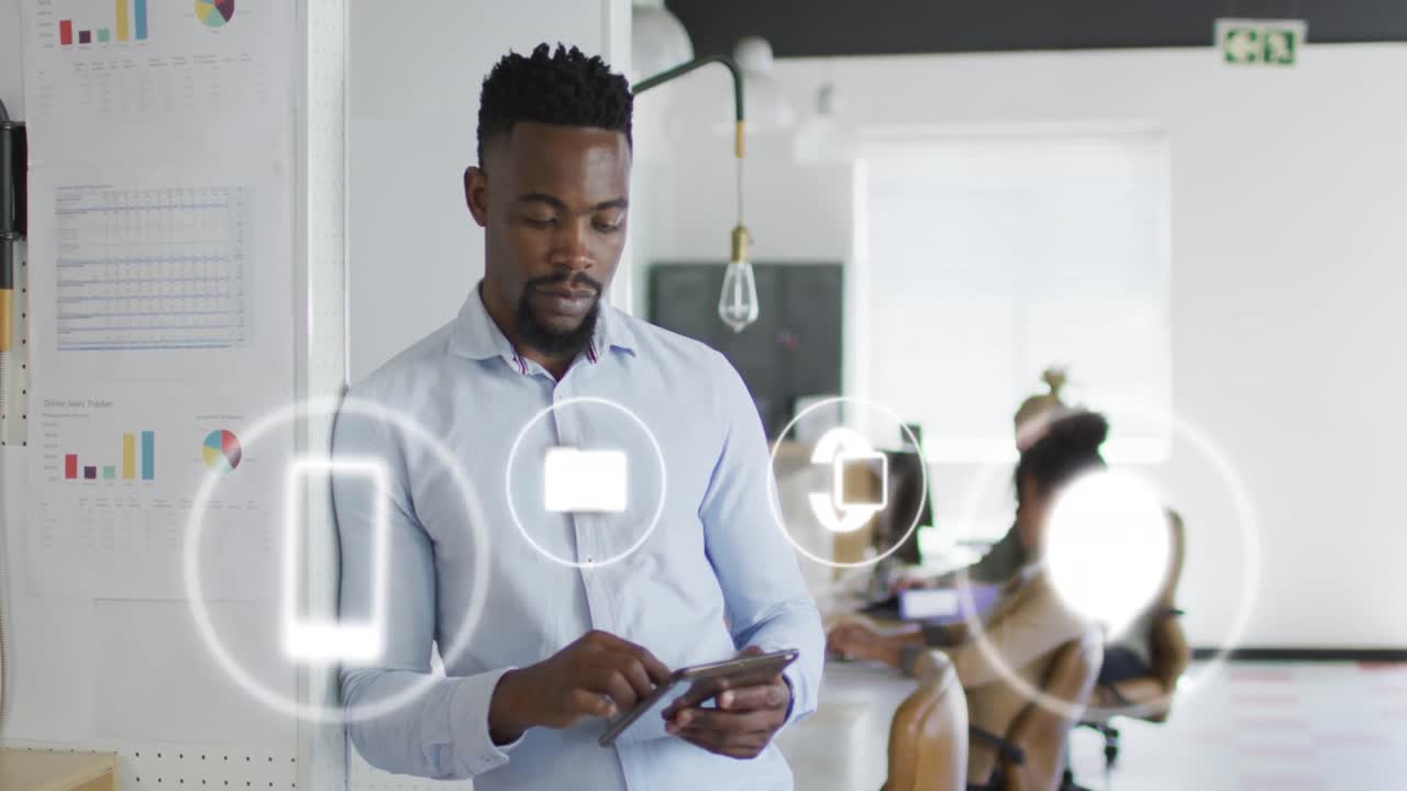 Animation of icons and data processing over african american businessman in office