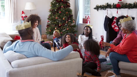 multi generation family talking and telling stories as they celebrate christmas at home together