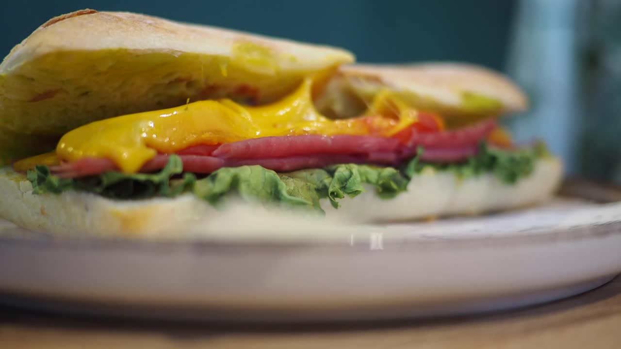 Sandwich with cheese, meat, and lettuce