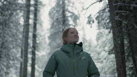woman enjoying a snowy winter day in a forest