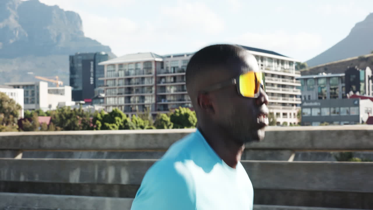 Determined Black Man Running Outdoors in Urban Environment