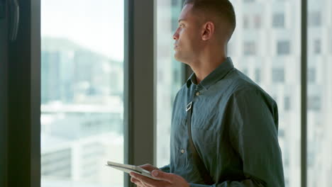 Architect,-tablet-and-man-thinking-by-window