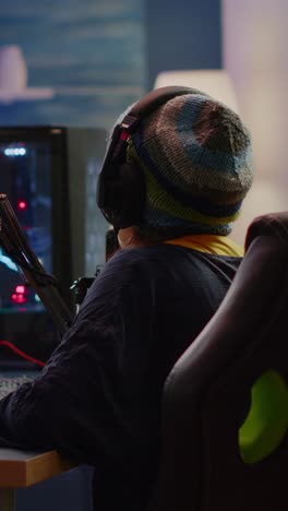 person with headphones and microphone engaged in gaming or streaming at a pc setup