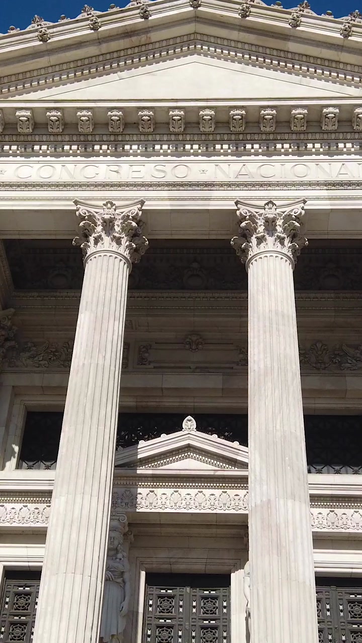Vertical low angle Argentina National Congress entrance with neoclassical columns and staircase Buenos Aires government landmark